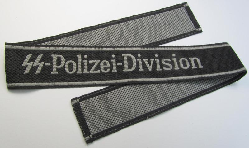 Superb, Waffen-SS, 1943/44 pattern cuff-title (ie. 'Ärmelstreifen') depicting the machine-woven Latin script text in silver-grey linnen as was intended for a member of the: '4. SS-Polizei-Panzergrenadier-Division' (ie. 'SS-Polizei-Division')