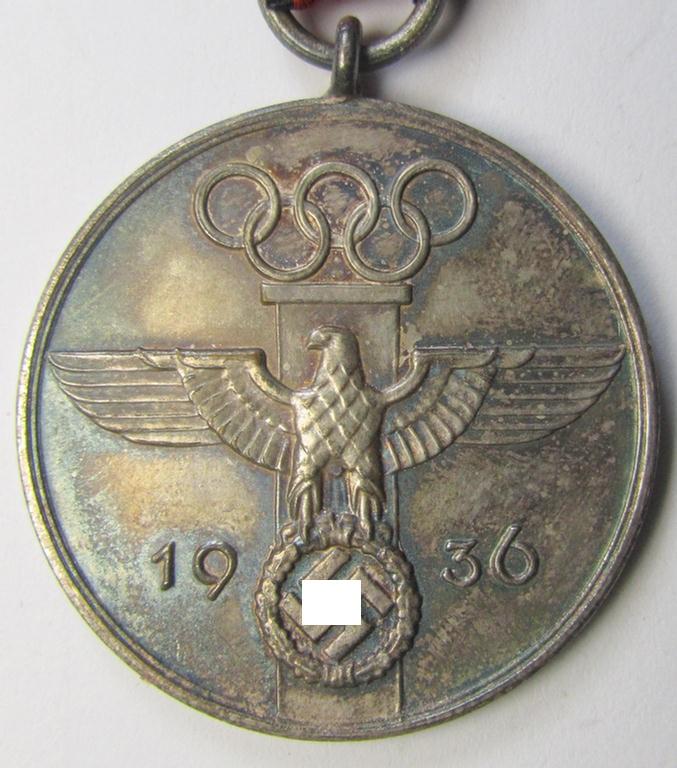 Superb, 'Deutsche Olympia-Erinnerungsmedaille 1936' being a non-maker-marked example that comes mounted onto its original ribbon (ie. 'Bandabschnitt') and that comes stored in its typical, beige-white-coloured etui as issued and stored for decades