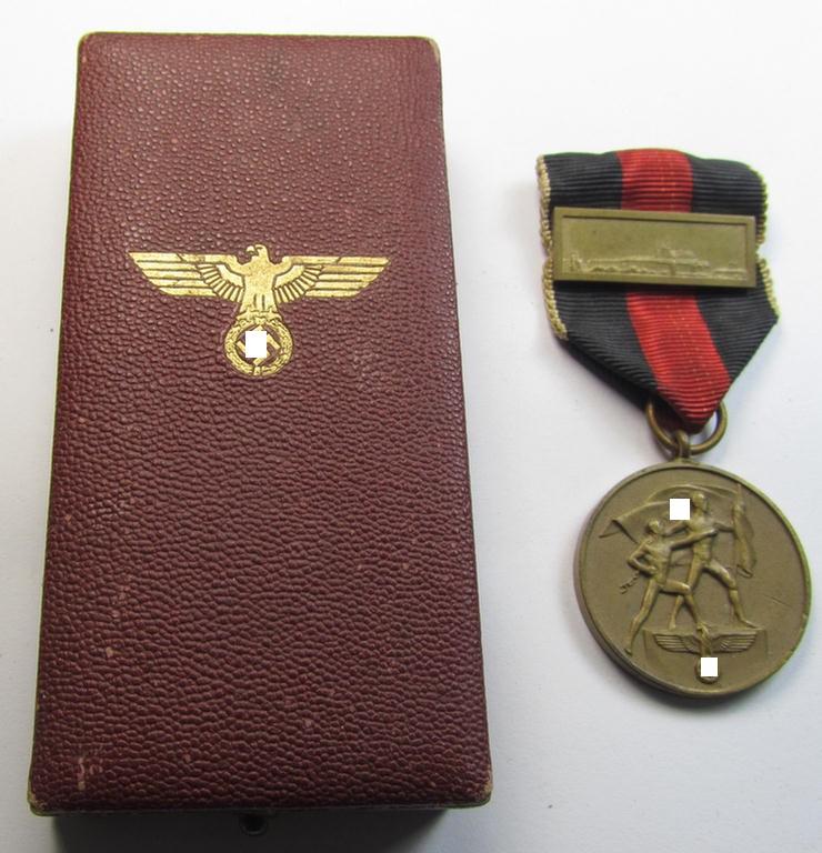 WH Czech-occupation- (ie. 'Anschluss'-) medal: '1. Oktober 1938' being an attractive and example that comes with its period-attached 'PB-Spange' and that comes stored in its bordeaux-red-coloured- and/or non-maker-marked etui
