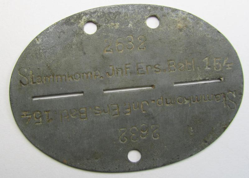 Attractive and typical zinc-based, WH (Heeres) related ID-disc bearing the clearly stamped unit-designation that reads: 'Stammkomp.Inf.Ers.Btl. 154' and that comes as issued- and/or worn
