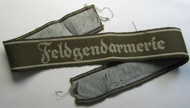 Superb - and scarcely encountered! - example of a WH (Heeres) cuff-title ie. armband (ie. 'Ärmelstreifen') entitled: 'Feldgendarmerie' (being an attractive example that comes in a full length- ie. non-shortened, condition)