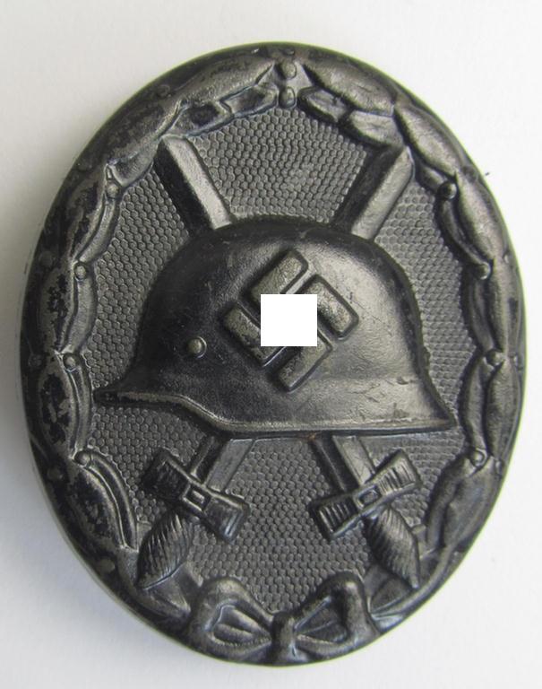 Dual-maker- (ie. 'E.H.'- and '126'-) marked example of a black-class wound-badge (or: 'Verwundeten-Abzeichen in Schwarz') being an example that was produced by the maker (ie. 'Hersteller') named: 'Eduard Hahn'