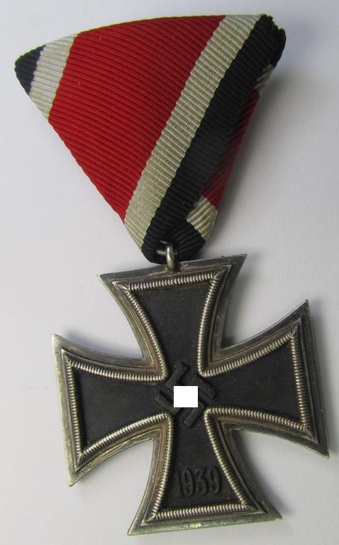 'Eisernes Kreuz II. Klasse' being a non-maker-marked example that comes mounted onto its original and Austrian-styled ribbon (ie. 'Bandabschnitt') as was (I deem) produced by the maker (ie. 'Hersteller'): 'Rudolf Souval'
