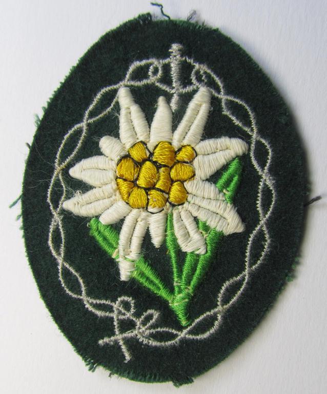 Attractive, WH (Heeres) enlisted-mens'- (ie. NCO-) type, so-called: 'Edelweiss'-armpatch, being a machine-embroidered example as was executed on darker-green wool as was intended for usage by the: 'Gebirgsjäger-Truppen' throughout the war