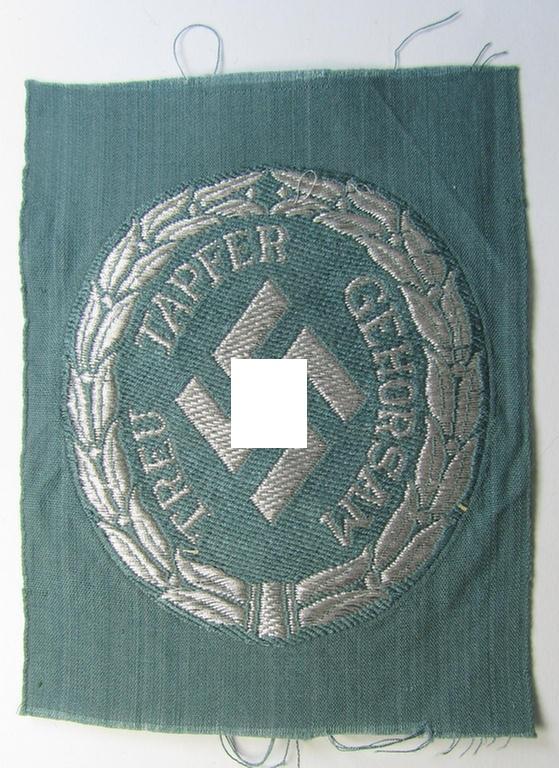 Superb - and actually rarely encountered! - officers'- (ie. evt. NCO-) type, so-called: 'Schutzmannschaften'- (ie. 'Schuma'-) armshield being executed in silver-grey-coloured 'flatwire'-thread onto a police-green-coloured background