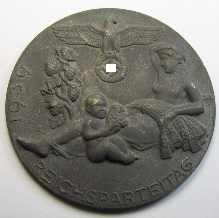 Attractive, larger-sized- and greyish-silver-toned so-called: award-plaque (or: 'Erinnerungs- o. nichttragbare Medaille') showing a 'Reichsadler'- and swastika-sign and illustration of a mother and child coupled with the text: 'Reichsparteitag 1939'