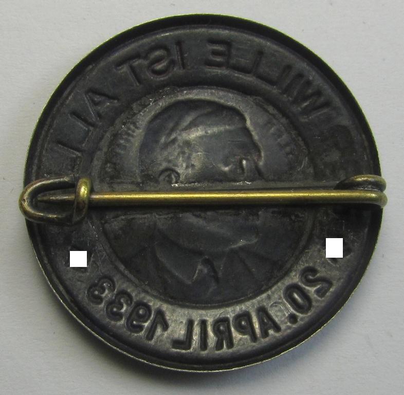 Superb, silverish-coloured and tin-based, N.S.D.A.P.-related day-badge (ie. 'tinnie' or: 'Veranstaltungsabzeichen') being a commemorative example that shows a portrait of Adolf Hitler surrounded by the text: 'Der Wille ist Alles - 20 April 1933'