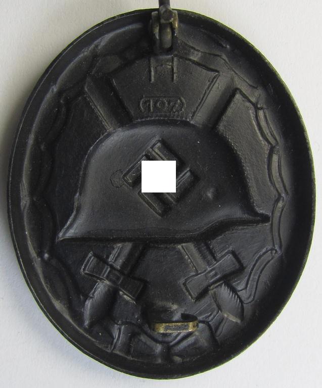 Attractive, nicely maker- (ie. '107-) marked example of a black-class wound-badge (or: 'Verwundeten-Abzeichen in Schwarz') being an example that was produced by the maker (ie. 'Hersteller') named: 'Carl Wild'