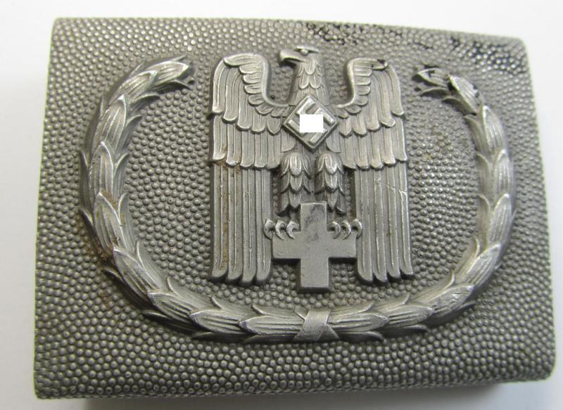 Aluminium-based so-called: DRK (ie. 'Deutsches Rotes Kreuz'), EM- (ie. NCO-) type belt-buckle being a non-maker- (albeit 'Ges.Gesch. 1'-) marked example that comes in a minimally worn- and/or hardly used, condition
