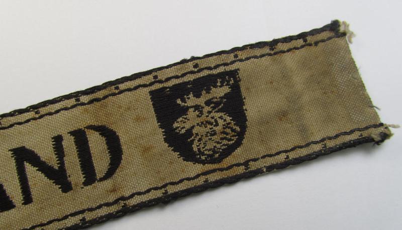 Superb, full-length example of a WH (Heeres ie. Kriegsmarine) cuff-title- ie. armband (ie. 'Ärmelstreifen') entitled: 'Kurland' that comes in an overall very nice- (albeit clearly used- ie. tunic-removed-), condition