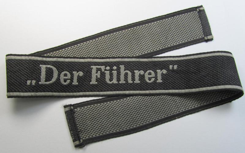 Stunning, Waffen-SS, 1943-pattern cuff-title (ie. 'Ärmelstreifen') depicting the machine-woven Latin script text in silver-grey linnen, as was intended for a member of the: 'SS-Regiment “Der Führer”