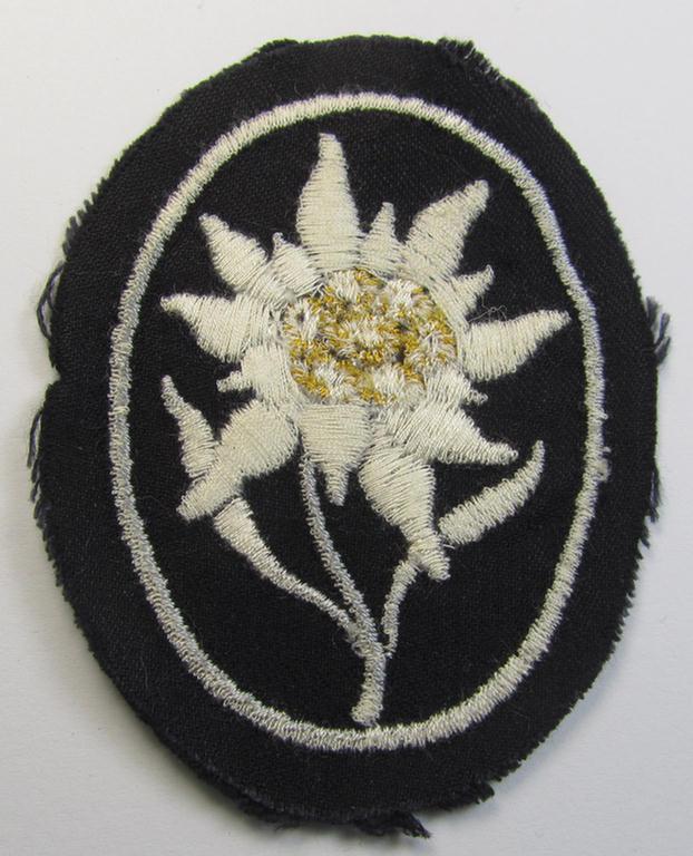 Waffen-SS-pattern, black-coloured sleeve-insignia (ie. 'Ärmelabzeichen') depicting an: 'Edelweiss'-flower, as used by the various 'Gebirgsjäger'- (ie. mountain-troops-) related divisional-staff