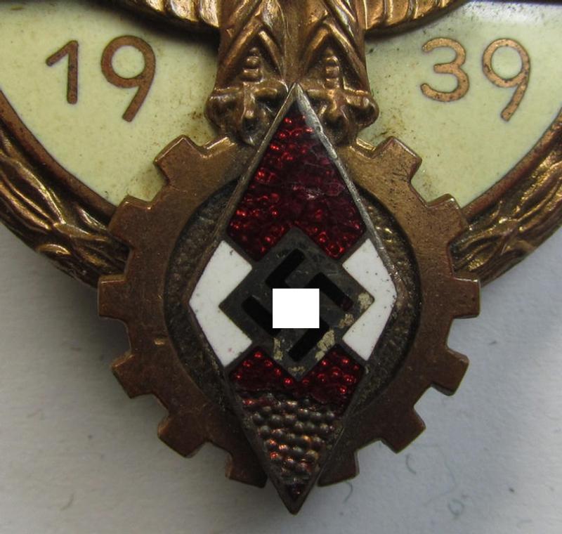 Clearly worn 'HJ'- ('Hitlerjugend') ie. 'BDM'- ('Bund Deutscher Mädel') related: 'Reichsberufswettkampf-Siegerabzeichen' (of the 2nd model) entitled: 'Kreissieger 1939' and being a neatly maker- (ie.: 'Hermann Aurich'-) marked example