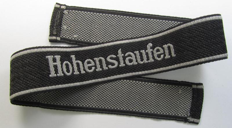 Superb, 1943/44 pattern Waffen-SS cuff-title, depicting the machine-woven 'Latin'-script text in silver-grey linnen as was intended for a member of the: '9. SS-Panzer-Division' “Hohenstaufen”