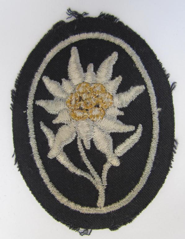 Waffen-SS-pattern, black-coloured sleeve-insignia (ie. 'Ärmelabzeichen') depicting an: 'Edelweiss'-flower, as used by the various 'Gebirgsjäger'- (ie. mountain-troops-) related divisional-staff