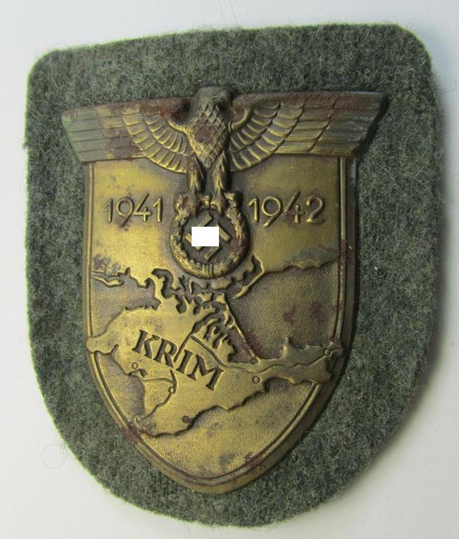 Attractive - albeit minimally rust-stained - WH (Heeres ie. Waffen-SS) 'Krim'-campaign-shield (as was produced by a by me unidentified maker) and that comes in a presumably issued - albeit 'virtually mint', condition