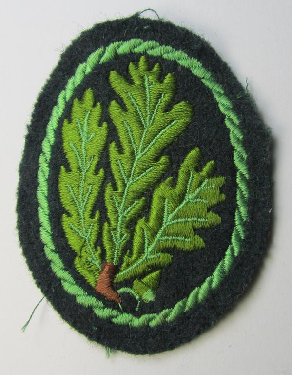 Truly worn- and/or carefully tunic-removed example of a WH (Heeres) so-called: 'Jäger'-armbadge being a neatly machine-embroidered- and/or multi-coloured version as was executed on darker-green-coloured wool