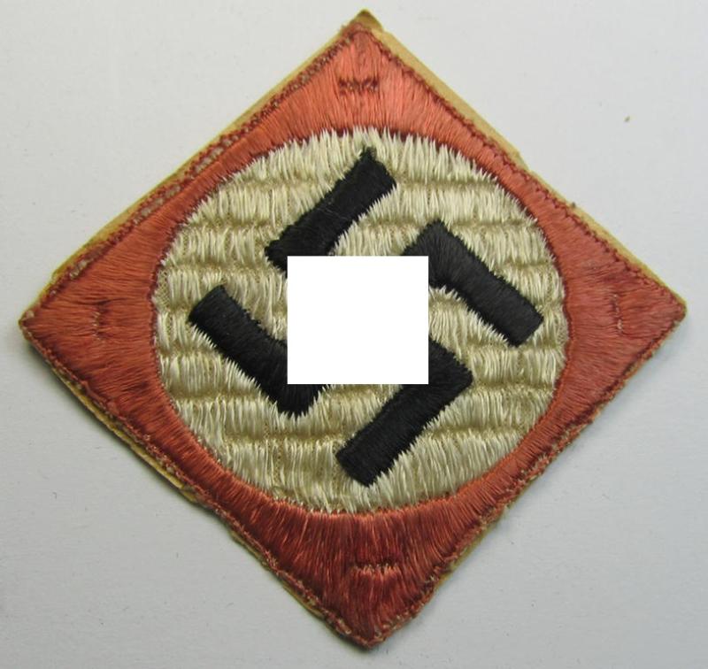 Unusually seen, multi-coloured (and nicely woven!) patriotic badge (ie. 'N.S.D.A.P.-supportive piece) being an example that shows a black-coloured swastika mounted onto a white- and black-coloured 'backing'