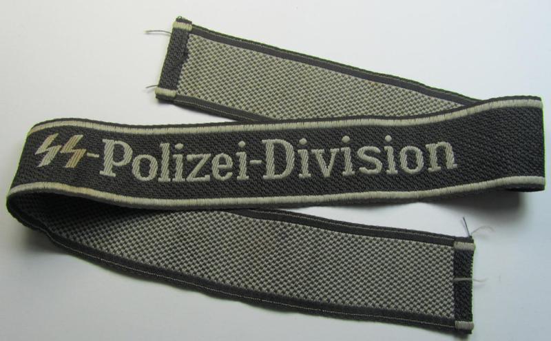 Superb, Waffen-SS, 1943/44 pattern cuff-title (ie. 'Ärmelstreifen') depicting the machine-woven Latin script text in silver-grey linnen as was intended for a member of the: '4. SS-Polizei-Panzergrenadier-Division' (ie. 'SS-Polizei-Division')