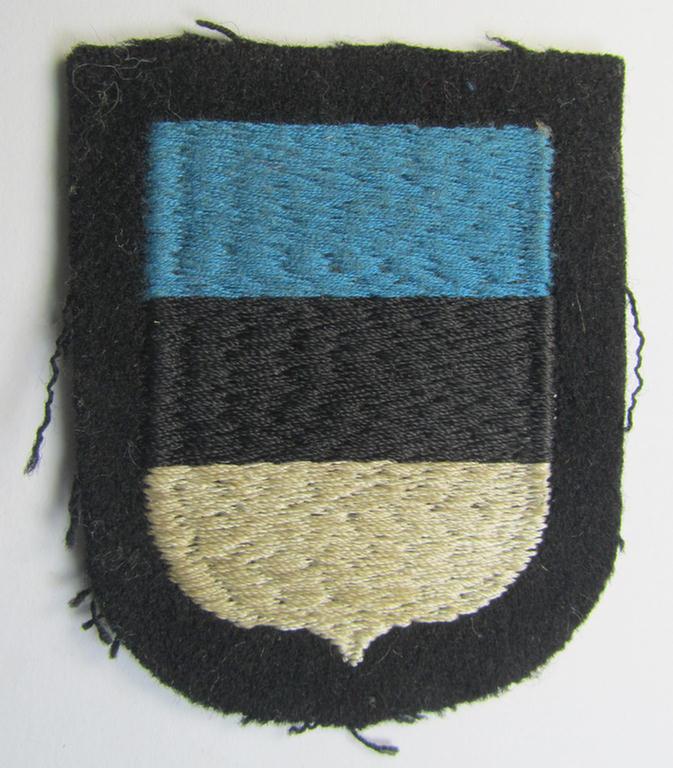 Attractive, Waffen-SS 'volunteer'-arm-shield as was intended for usage by soldiers of the: '20. Waffen-Grenadier-Division der SS' (ie. 'estnische Nr. 1') and that comes in a 'virtually mint- ie. unissued', condition