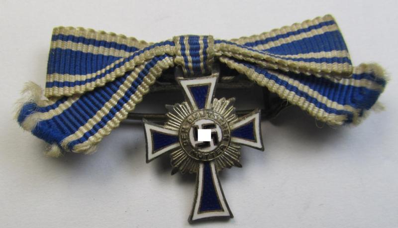 Miniature of an: 'Ehrenkreuz der deutschen Mutter - zweite Stufe' (or: silver-class mothers'-cross) being a maker- (ie. 'L/16'-) marked example that comes in an overall nice- (albeit moderately worn- ie. used-), condition