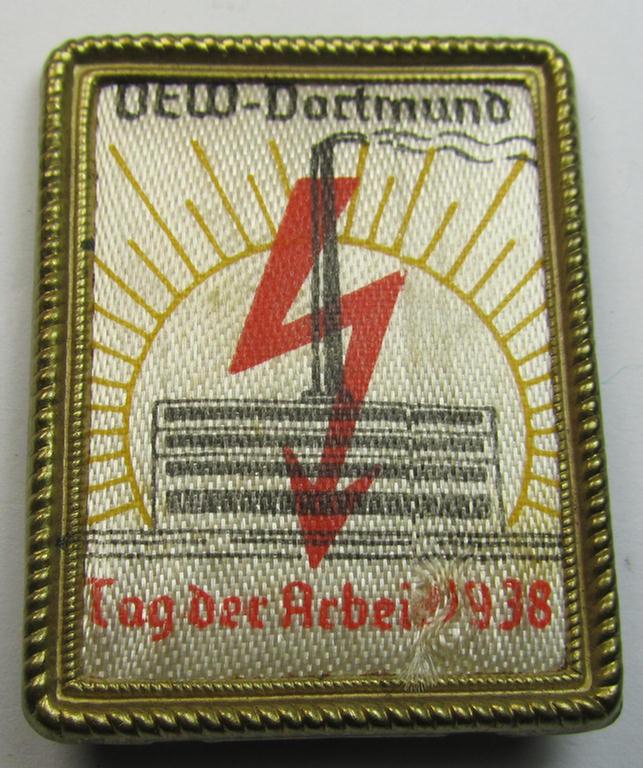 Commemorative - tin- (ie. linnen-) based 'tinnie' being a maker- (ie. 'Stuco'-) marked example depicting a 'sunburst' with swastika and text that reads: 'V.E.W. - Dortmund - Tag der Arbeit 1938'