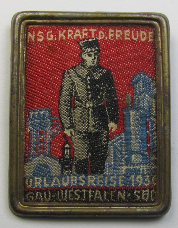 Commemorative - tin- (ie. linnen-) based-, 'KDF' (ie. 'Kraft durch Freude')-related 'tinnie' being a non-maker-marked example depicting a soldier with above and below the text: 'NSG. Kraft durch Freude - Urlaubsreise 1936'