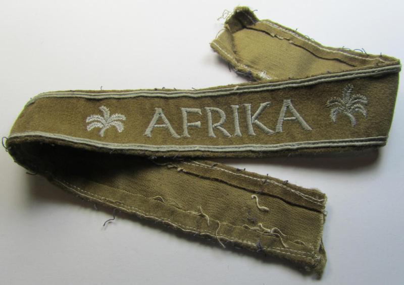 Attractive - and clearly worn! - WH cuff-title (ie. 'Ärmelstreifen') entitled: 'Afrika' (being an almost full-length example that comes in an overall very nice- ie. issued and clearly worn ie. once tunic-attached, condition)