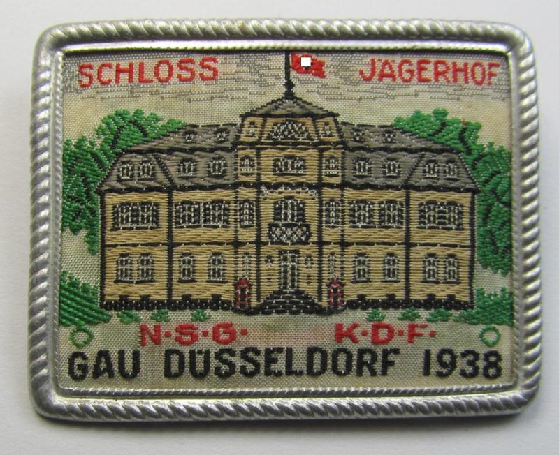 Commemorative - tin- (ie. linnen-) based-, 'DAF'/'KDF'- (ie. 'Deutsches Arbeits Front'-) related 'tinnie' being a non-maker-marked example depicting a castle with swastika-flag and text: 'Schloss Jägerhof - N.S.G. K.D.F. Gau Düsseldorf - 1938'