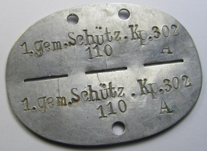 Attractive, aluminium-based WH (Heeres, LW usw.) ie. 'Schützen'-related ID-disc (ie. 'Erkennungsmarke') bearing the clearly stamped unit-designation that reads: '1.gem.Schütz.Kp. 302' and that comes as issued- and/or worn