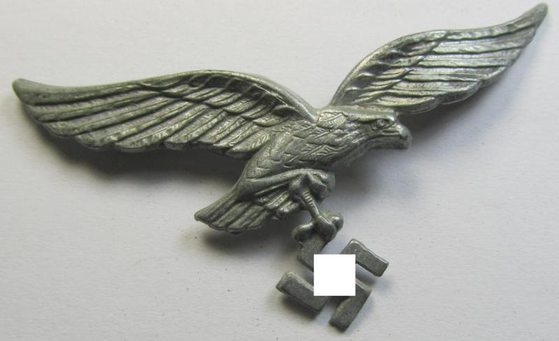 Neat - and I deem never used- nor cap-attached - greyish-silver-toned- and/or typical zinc- (ie. 'Feinzink'-) based, WH (Luftwaffe) visor- (ie. 'Schirmmützen'-) cap-eagle (being a maker- (ie. 'A'-) marked example of the regular second-type pattern)