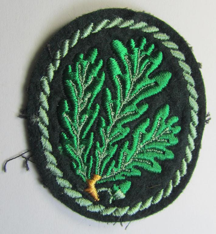 Attractive example of a WH (Heeres) so-called: 'Jäger'-armbadge being a neatly machine-embroidered- and/or multi-coloured version as was executed on darker-green-coloured wool