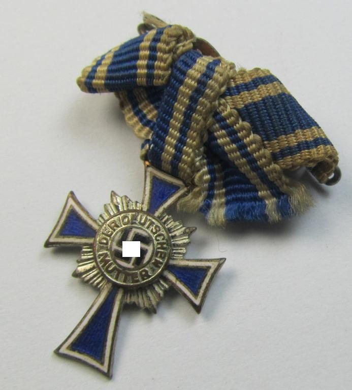 Miniature of an: 'Ehrenkreuz der deutschen Mutter - zweite Stufe' (or: silver-class mothers'-cross) being a non-maker-marked example that comes in an overall nice- (albeit moderately worn- ie. used-), condition