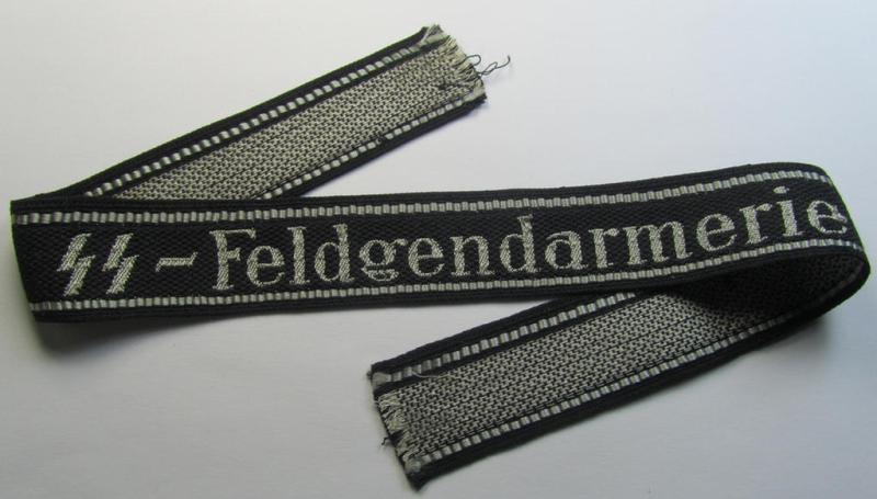 Superb - and truly rarely encountered! - example of a Waffen-SS, 'semi-BeVo'-pattern, EM- (ie. NCO-) type cuff-title (ie. 'Ärmelstreifen') as was intended for a member serving within the: 'SS-Feldgendarmerie'