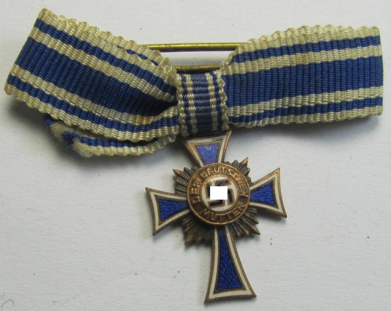 Miniature of an: 'Ehrenkreuz der deutschen Mutter - dritte Stufe' (or: bronze-class mothers'-cross) being a non-maker-marked example that comes in an overall nice- (albeit moderately worn- ie. used-), condition