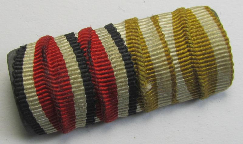 Two-pieced ribbon-bar (ie. 'Band- o. Feldspange') depicting respectively the ribbons an: 'Eisernes Kreuz II. Klasse' (or: iron cross second class) and a: 'Westwall'-medal