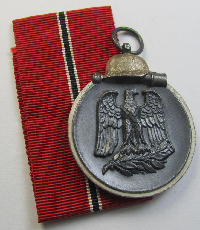 Attractive, '1957'-pattern: 'Medaille Winterschlacht im Osten 1941-42' and that comes together with its full-length- (ie. non-confectioned- and/or 'virtually mint') ribbon (ie. 'Bandabschnitt') as issued and recently found