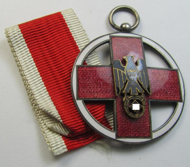 Superb - and nicely enamelled! - so-called: 'DRK-Ehrenzeichen des 3. Modell' that comes together with its original (regular-sized- and once-mounted) ribbon (ie. 'Bandabschnitt') as issued and/or stored for decades