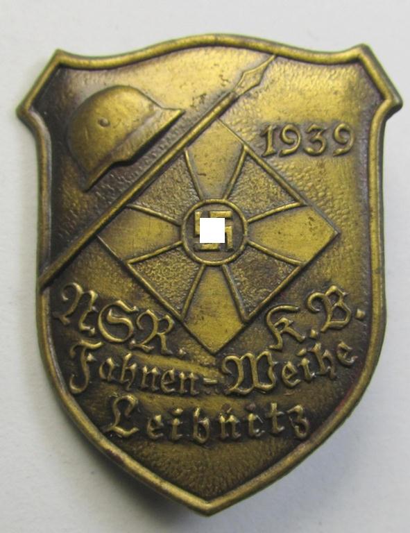 Neat, golden-bronze-toned, 'Nationalsocialistischer Reichskriegerbund'- (ie. 'N.S.R.K.B.'-) related day-badge (ie. 'tinnie') being a: 'Schweriner & Cie - Graz-Eggenberg'-marked example entitled: 'N.S.R.K.B. Fahnen-Weihe - Leibnitz - 1939'