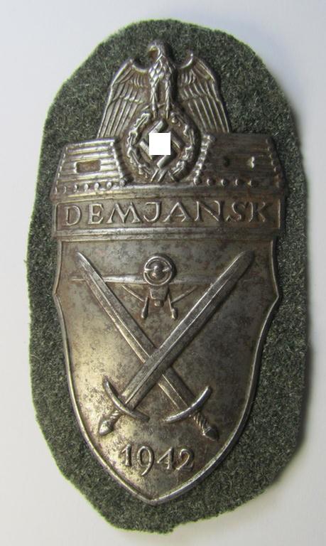 Attractive example of a - fairly scarcely encountered! - WH (Heeres ie. Waffen-SS) 'Demjansk'-campaign-shield as executed in typical magnetic, so-called: 'Eisenblech' (and being of the 'missing-log' variant-pattern)