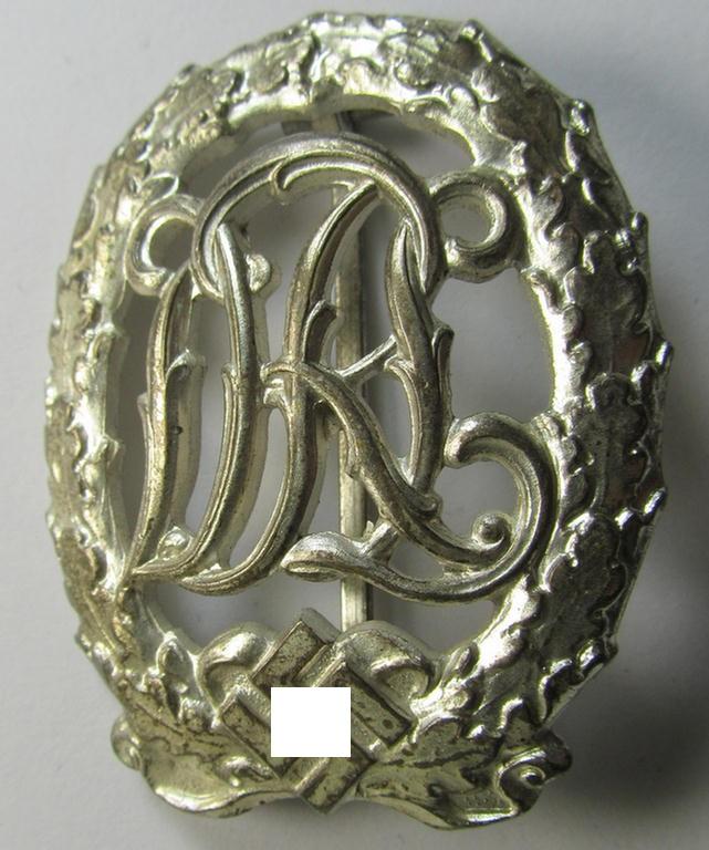 Attractive, 'Reichssportabzeichen DRL in Silber' (or: silver-class DRL sports'-badge) being a typical zinc- (ie. 'Feinzink'-) based example that is nicely maker- (ie. 'Wernstein - Jena'-) marked on its back