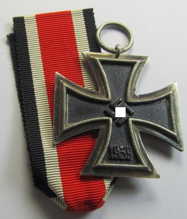 'Eisernes Kreuz II. Klasse' being a maker- (ie. '19'-) marked example that comes together with its once-mounted ribbon (ie. 'Bandabschnitt') as was produced by the maker (ie. 'Hersteller'): 'E.Ferd. Wiedmann'