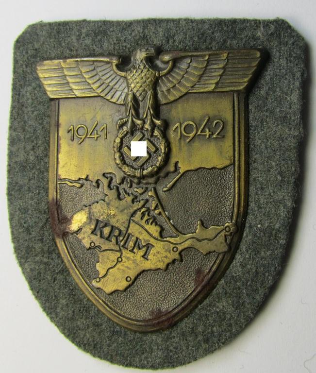 Attractive - albeit minimally rust-stained - WH (Heeres ie. Waffen-SS) 'Krim'-campaign-shield (as was produced by a by me unidentified maker) and that comes in a presumably issued - albeit 'virtually mint', condition
