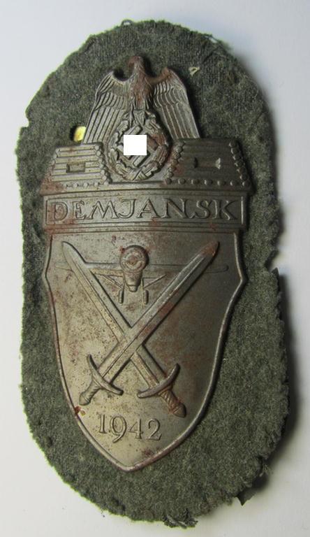Attractive - and moderately used- ie. tunic-removed! - example of a WH (Heeres ie. Waffen-SS) so-called: 'Demjansk'-campaign-shield as executed in magnetic, so-called: 'Eisenblech'