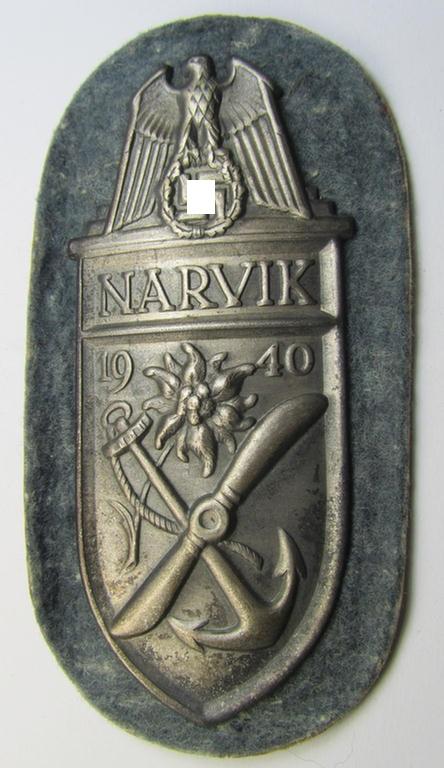 Superb - and scarcely encountered! - WH (Heeres) 'Narvik'-campaign-shield being a detailed example as executed in silver-toned metal and that comes in a presumably issued- (albeit never worn- nor tunic-attached-), condition