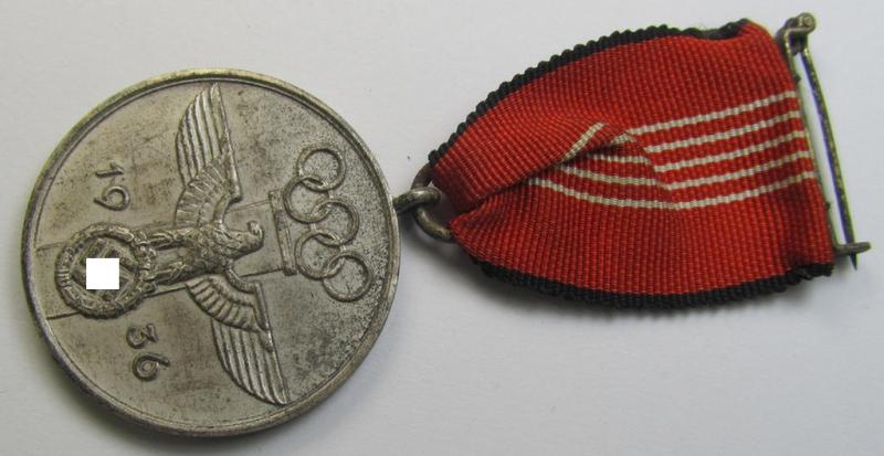 Superb, 'Deutsche Olympia-Erinnerungsmedaille 1936' being a non-maker-marked example that comes mounted onto its original (bright-red-coloured ribbon (ie. 'Bandabschnitt') as issued and/or stored for decades