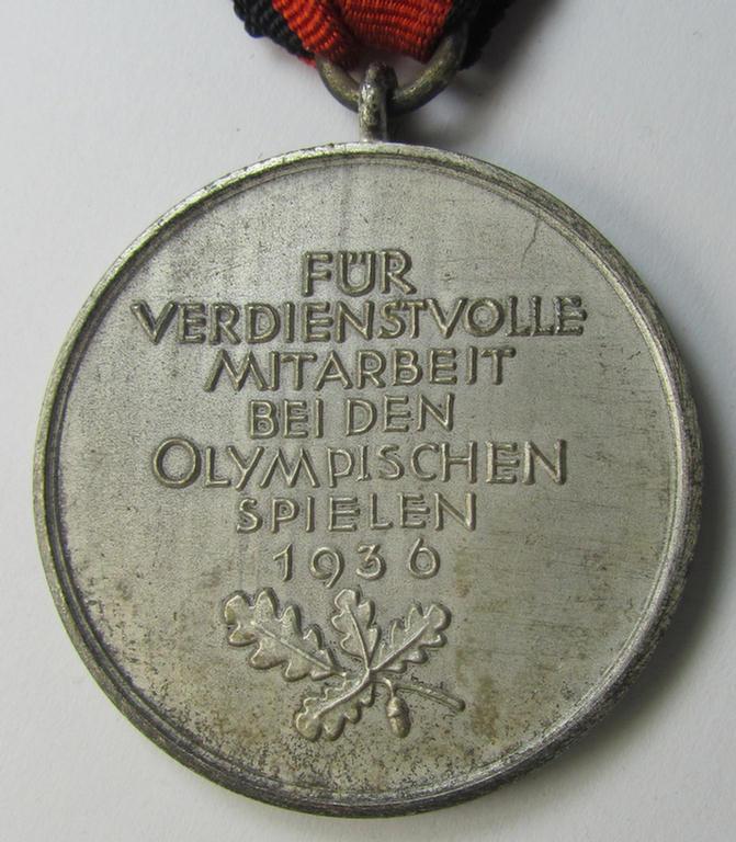 Superb, 'Deutsche Olympia-Erinnerungsmedaille 1936' being a non-maker-marked example that comes mounted onto its original (bright-red-coloured ribbon (ie. 'Bandabschnitt') as issued and/or stored for decades
