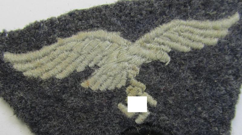 Attractive - and scarcely encountered! - WH (Luftwaffe) so-called: 'M43-pattern'-cap-trapezoid (being a machine-embroidered and carefully cap-removed example that is executed on a bluish-grey-coloured- and/or woolen-based background)