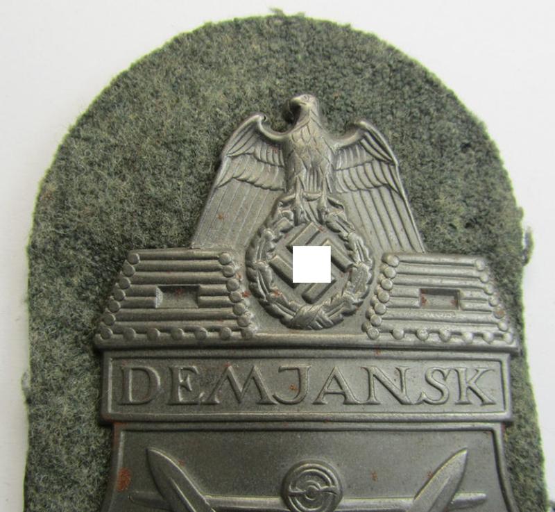 Attractive - and moderately used- ie. tunic-removed! - example of a WH (Heeres ie. Waffen-SS) so-called: 'Demjansk'-campaign-shield as executed in magnetic, so-called: 'Eisenblech'