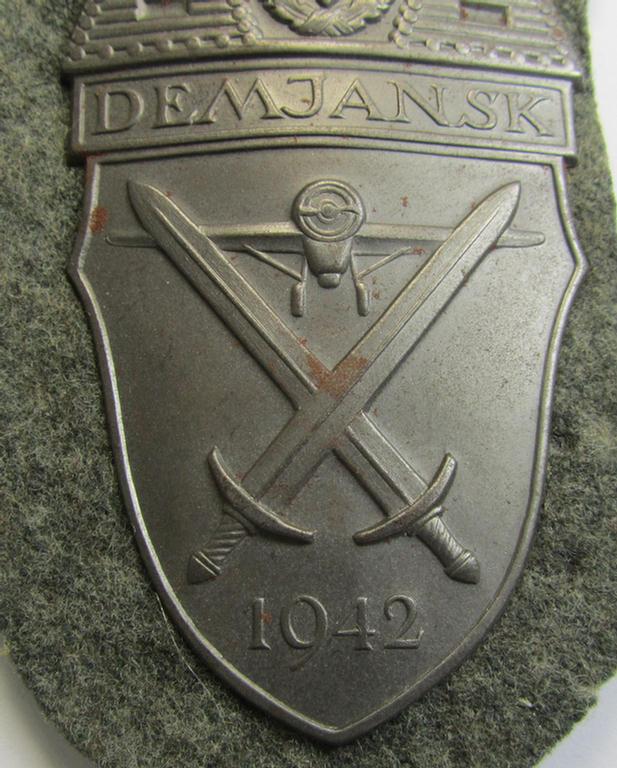 Attractive - and moderately used- ie. tunic-removed! - example of a WH (Heeres ie. Waffen-SS) so-called: 'Demjansk'-campaign-shield as executed in magnetic, so-called: 'Eisenblech'